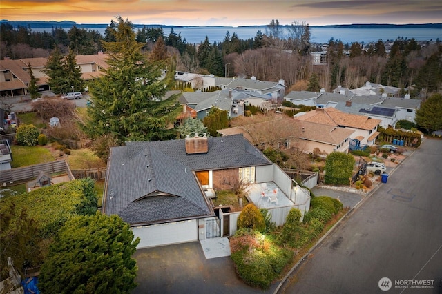 aerial view at dusk with a water view