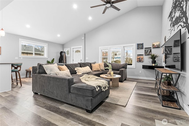 living room with dark hardwood / wood-style flooring, high vaulted ceiling, and ceiling fan