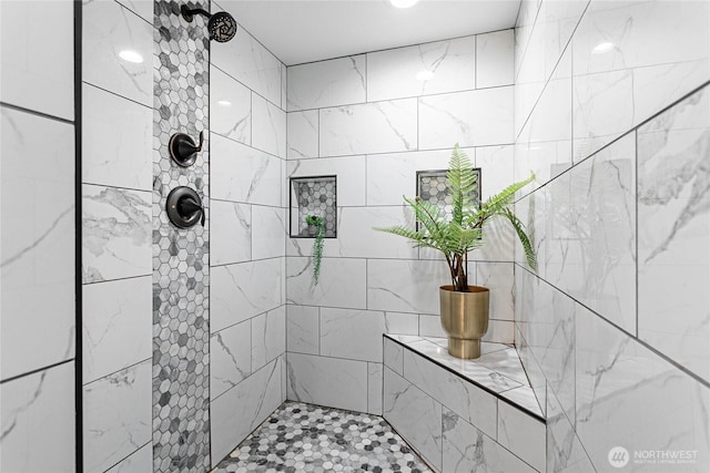 bathroom with a tile shower