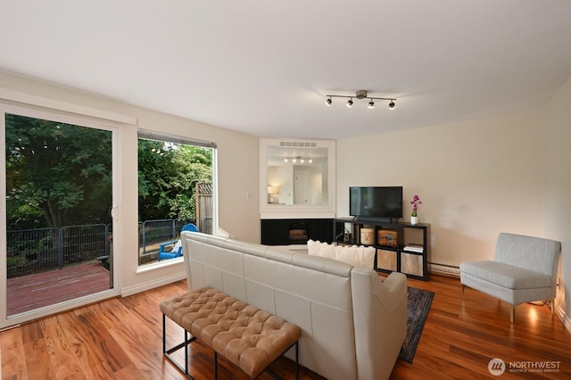 220 SW 200th St Unit 186, Normandy Park, WA 98166 - living room featuring light wood-type flooring and baseboard heating