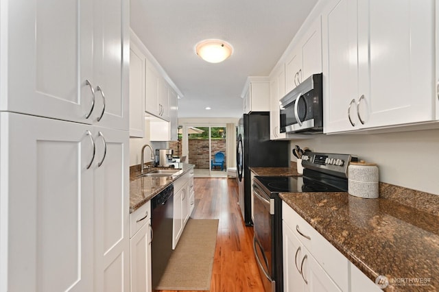 220 SW 200th St Unit 186, Normandy Park, WA 98166 - kitchen with appliances with stainless steel finishes, white cabinets, and light wood-style flooring