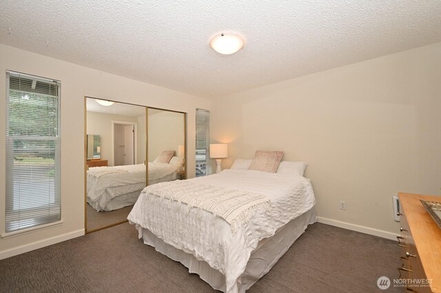 220 SW 200th St Unit 186, Normandy Park, WA 98166 - bedroom featuring dark carpet, a closet, and a textured ceiling