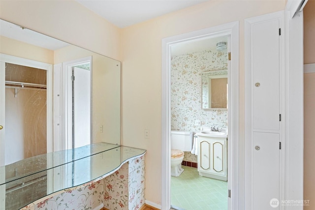 bathroom featuring vanity and toilet