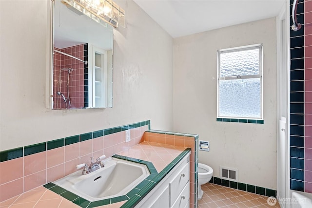 bathroom featuring vanity, tile patterned floors, toilet, and walk in shower