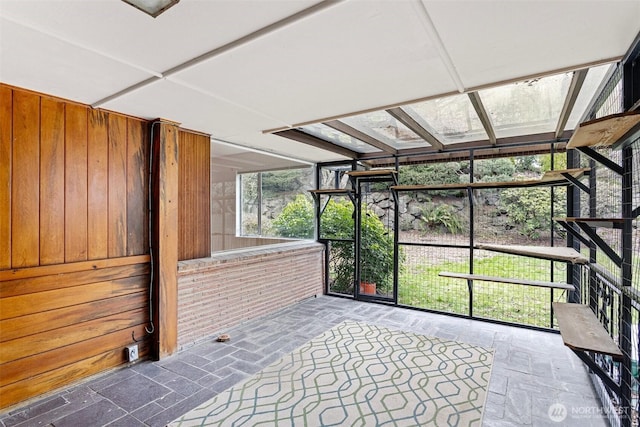 unfurnished sunroom featuring a skylight