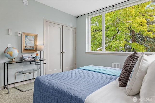 bedroom featuring a closet and visible vents