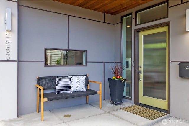 doorway to property featuring stucco siding