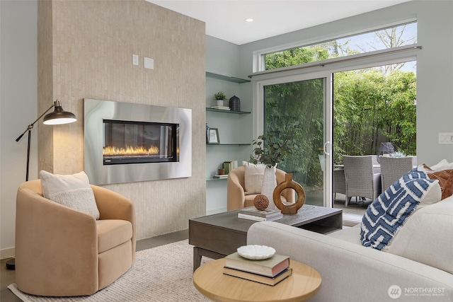 living room featuring a glass covered fireplace