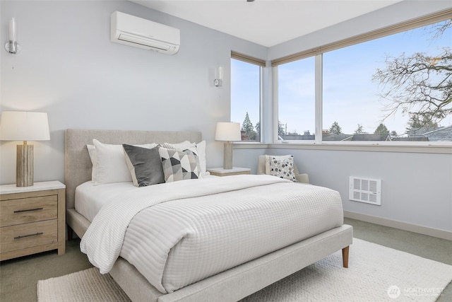 carpeted bedroom with a wall mounted air conditioner, visible vents, and baseboards