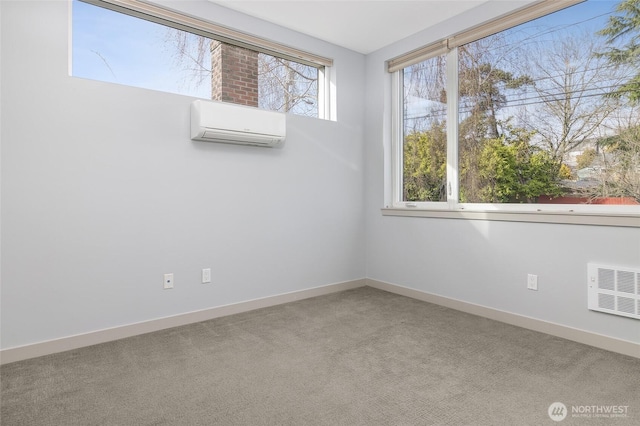 carpeted spare room with visible vents, baseboards, and a wall mounted air conditioner