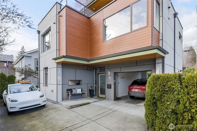 view of side of home featuring driveway and stucco siding