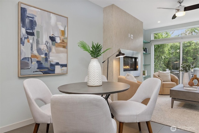 dining room with recessed lighting, a glass covered fireplace, a ceiling fan, and baseboards