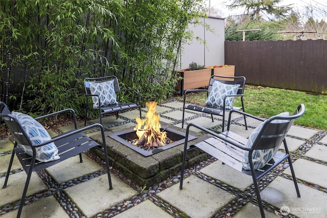 view of patio / terrace featuring a fire pit and fence