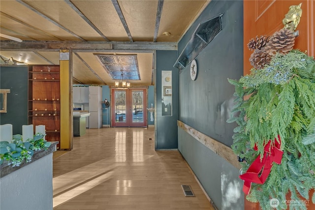 28622 SE 434th St, Enumclaw, WA 98022 - hallway with french doors, a chandelier, and hardwood / wood-style floors