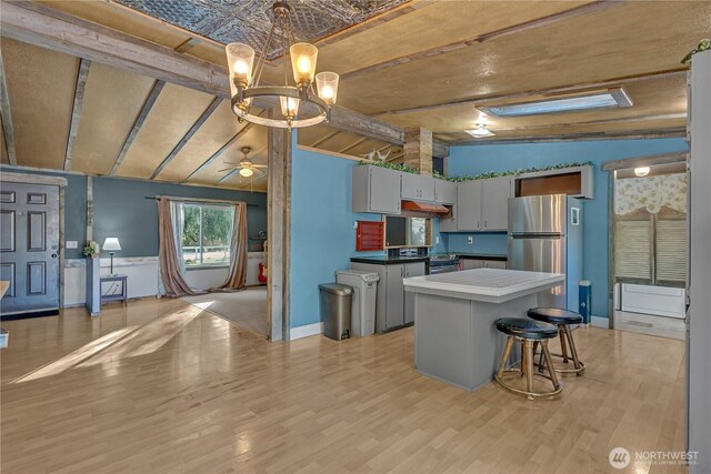 28622 SE 434th St, Enumclaw, WA 98022 - kitchen with lofted ceiling with beams, gray cabinetry, a center island, light hardwood / wood-style floors, and stainless steel appliances