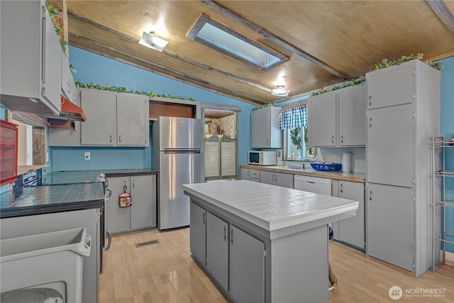 28622 SE 434th St, Enumclaw, WA 98022 - kitchen featuring white appliances, white cabinetry, a center island, vaulted ceiling, and light wood-type flooring