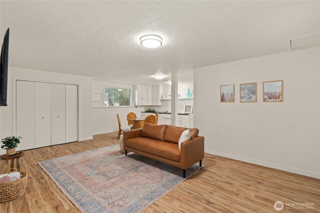 1508 Hoquiam Ln S, Westport, WA 98595 - living room featuring light hardwood / wood-style flooring and a textured ceiling