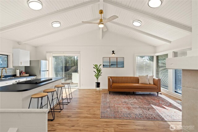 1508 Hoquiam Ln S, Westport, WA 98595 - living room featuring sink, lofted ceiling with beams, light hardwood / wood-style flooring, wooden ceiling, and ceiling fan