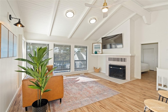 1508 Hoquiam Ln S, Westport, WA 98595 - living room with a tile fireplace, high vaulted ceiling, ceiling fan, light hardwood / wood-style floors, and beam ceiling