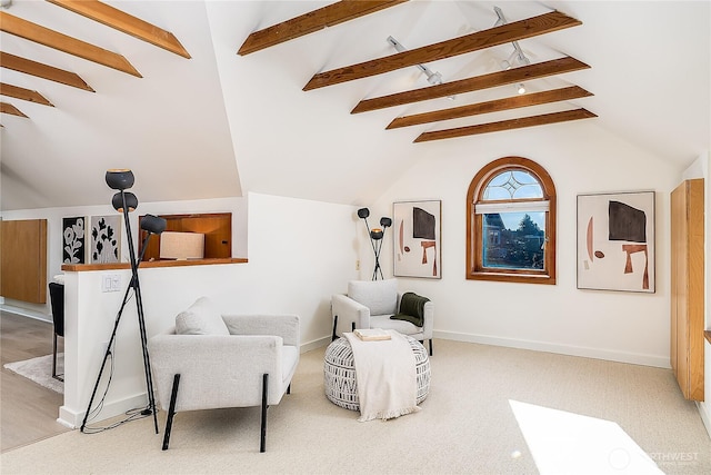 sitting room with carpet, lofted ceiling with beams, and baseboards