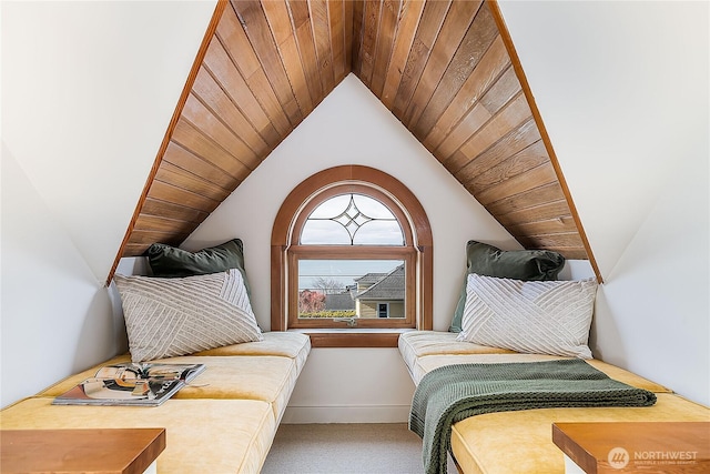 carpeted bedroom featuring lofted ceiling, wood ceiling, and baseboards