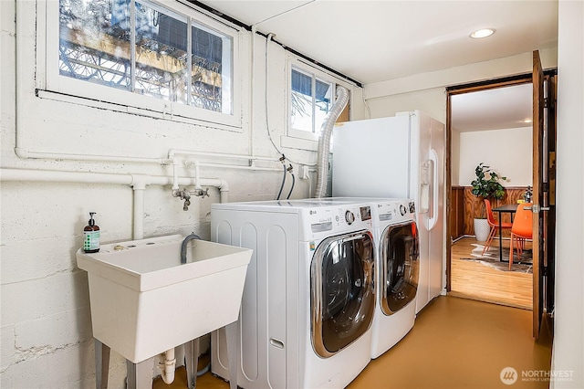 washroom with a sink and washer and clothes dryer