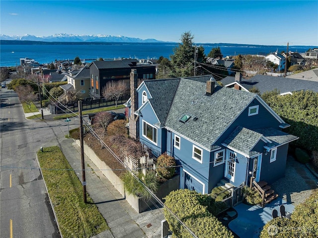 bird's eye view featuring a residential view and a water and mountain view