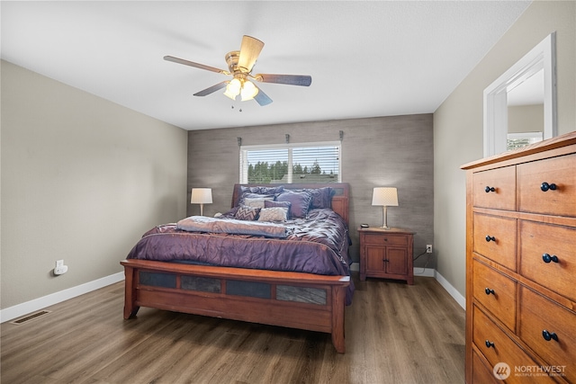 bedroom featuring ceiling fan and dark hardwood / wood-style flooring