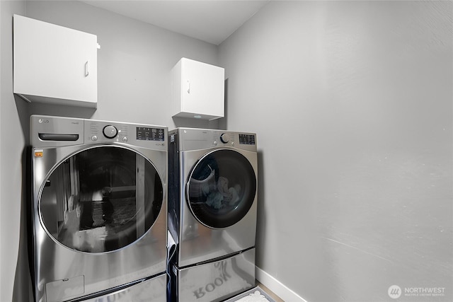 clothes washing area featuring independent washer and dryer