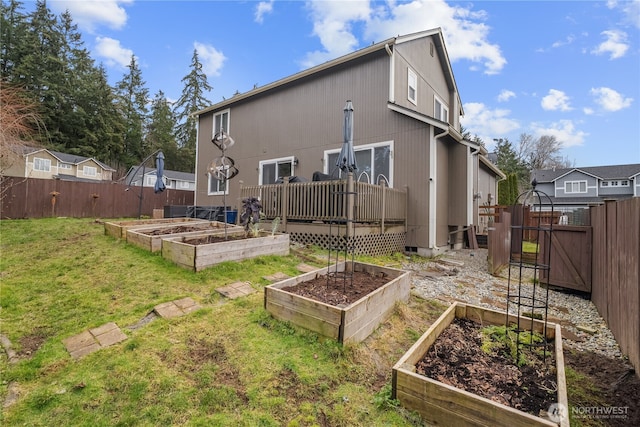 rear view of property featuring a lawn and a deck