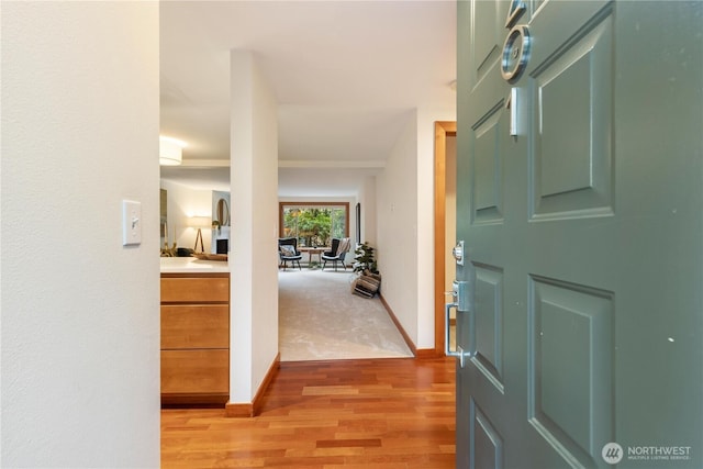 entryway featuring light wood finished floors and baseboards