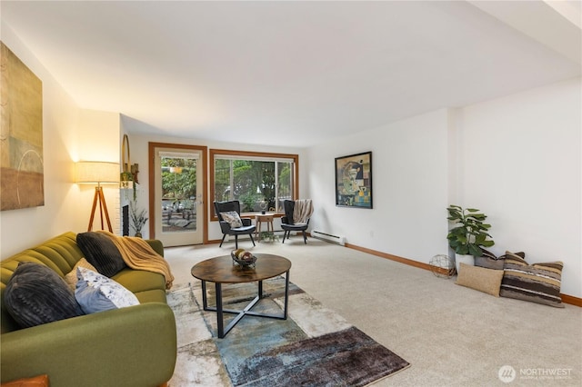 living room with a baseboard heating unit, baseboards, and carpet flooring