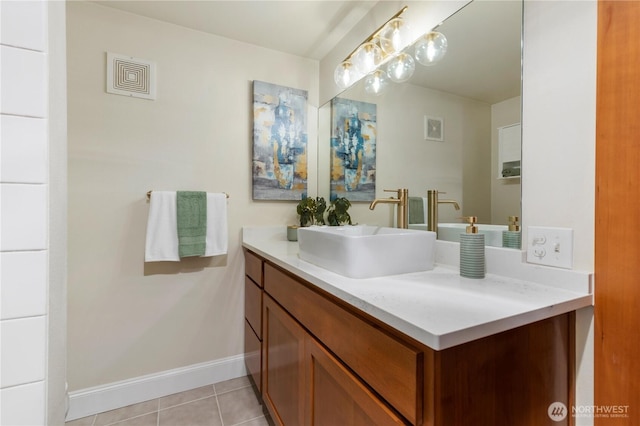 bathroom with visible vents, vanity, baseboards, and tile patterned floors