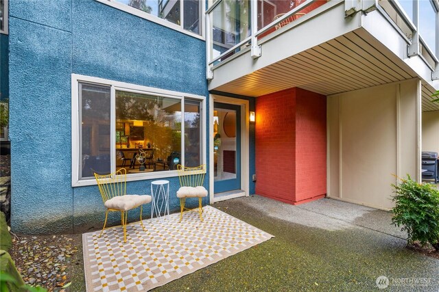 exterior space featuring a patio and stucco siding