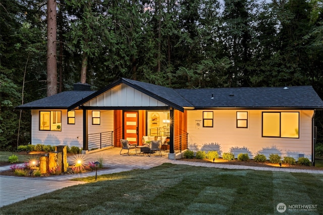 view of front of property featuring a front lawn and a patio area