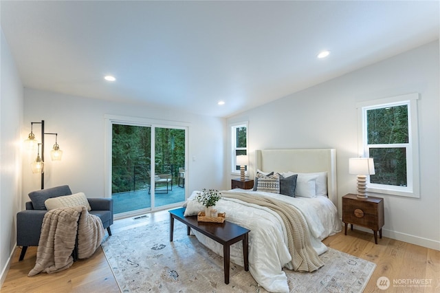 bedroom with light hardwood / wood-style flooring, access to exterior, and lofted ceiling