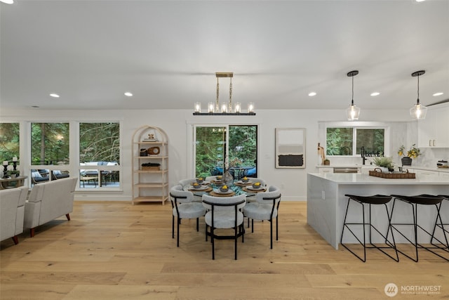 2641 271st Ave SE, Issaquah, WA 98029 - dining area with light wood finished floors, a notable chandelier, and recessed lighting