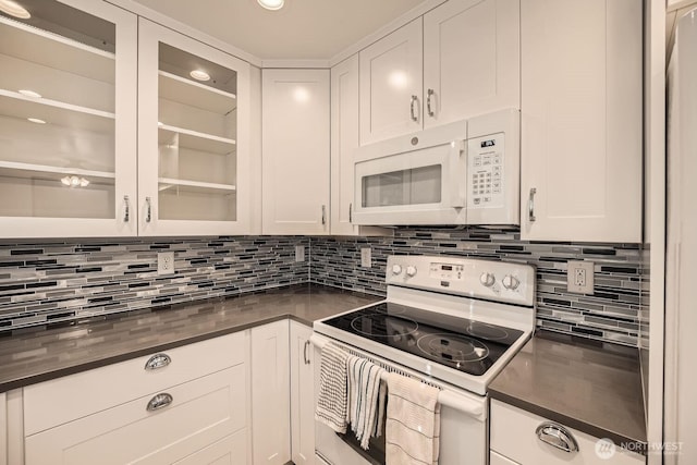 kitchen with tasteful backsplash, white cabinets, and white appliances