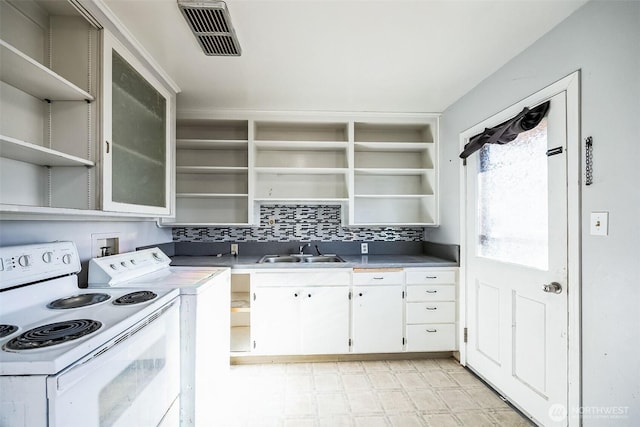 kitchen featuring white electric range, white cabinetry, washer / dryer, sink, and backsplash