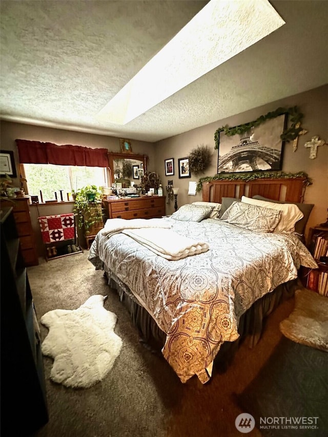 carpeted bedroom with a textured ceiling