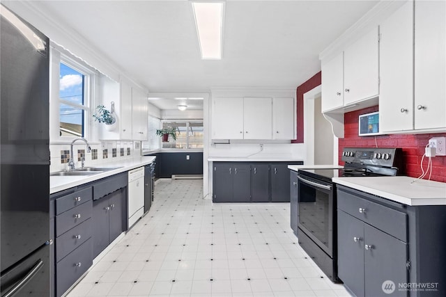 kitchen with sink, white cabinetry, white dishwasher, electric stove, and decorative backsplash