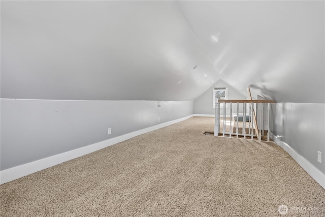 additional living space with lofted ceiling and carpet