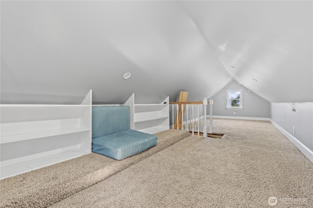 interior space with vaulted ceiling and carpet flooring