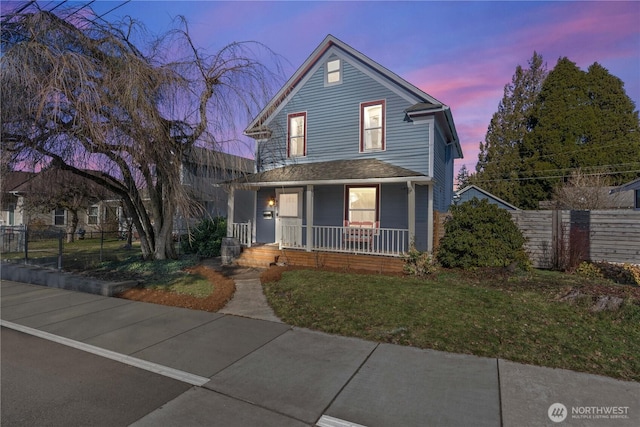 view of front facade with a yard and covered porch