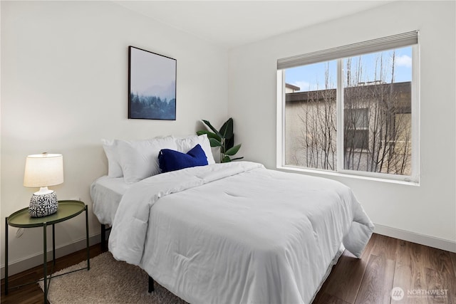 bedroom with dark hardwood / wood-style flooring