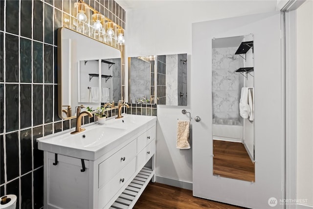 bathroom with vanity, hardwood / wood-style floors, and tile walls