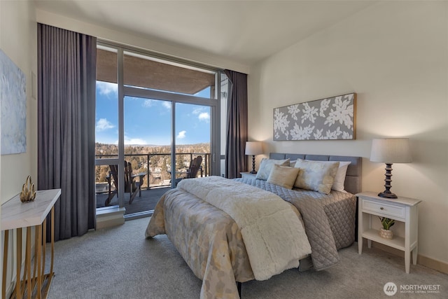 bedroom with floor to ceiling windows, access to exterior, and carpet floors