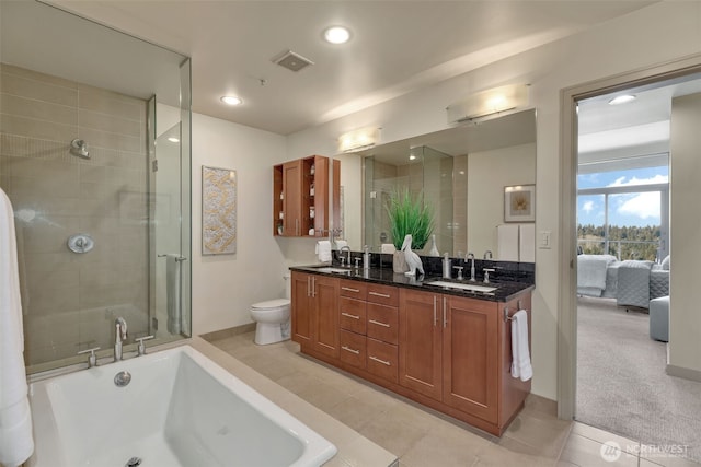 full bathroom featuring vanity, toilet, separate shower and tub, and tile patterned flooring