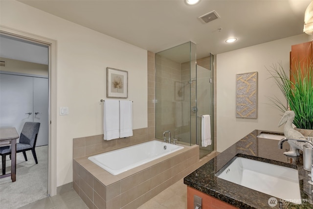 bathroom with independent shower and bath, vanity, and tile patterned flooring