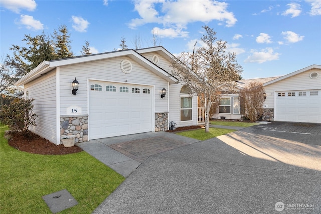 ranch-style house with a garage and a front yard